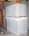 Concrete crawl space support posts in Modesto that are showing signs of failure as they sink into the earth.