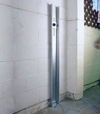 A failing foundation wall repaired with a foundation wall channel anchor system in a Fresno home.
