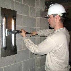 installing a wall anchor to repair an bowing foundation wall in Anaheim