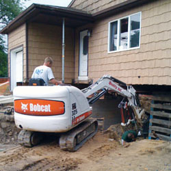 Excavating to expose the foundation walls and footings for a replacement job in Santa Ana