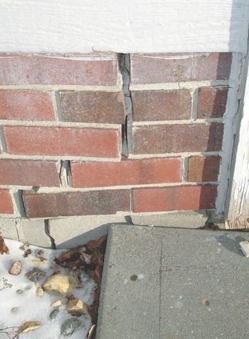 Severe street creep damage to a garage wall outside a Ontario home