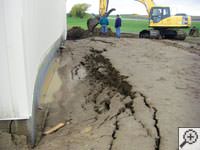 A foundation wall showing severe damage from bowing and buckling in San Bernardino