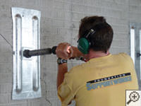 Mounting the steel wall plate for foundation wall repair and straightening in Moreno Valley.