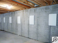 Wall anchor covers installed along a foundation wall that has been straightened in Pasadena.