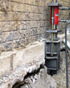 A completed installation of foundation push piers lifting a foundation in San Bernardino