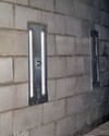 an inside view of foundation wall anchors installed along a basement wall to brace and repair the structure in Fremont